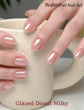 Wahrshei manicured hand wearing glazed donut pink strips, demonstrates easy home result