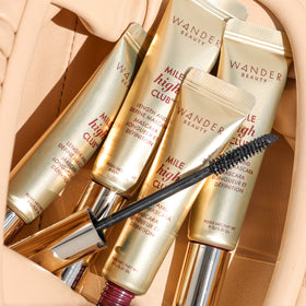 Wander Beauty mascara held in hand showing 0.31 fl oz scale