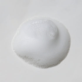 Weleda gentle cleansing face foam next to a smartphone for size and portability