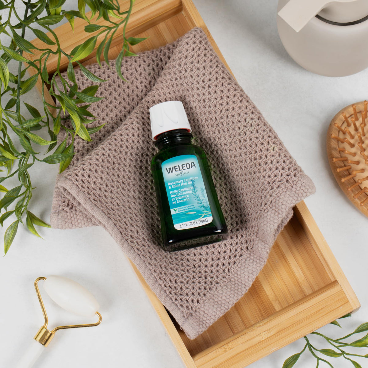 Weleda oil applied to hands and hair demonstrating easy application and smooth finish
