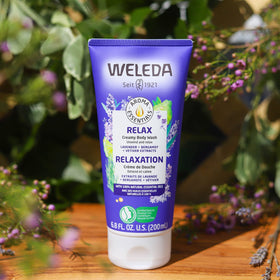 Weleda bottle beside toiletry bag showing travel-size convenience benefit