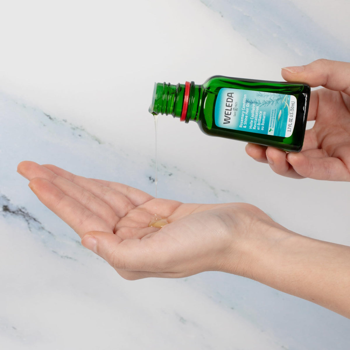 Weleda 1.7 fl oz bottle next to passport for travel-ready nourishment
