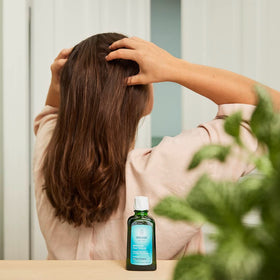 Weleda rosemary oil pouring close-up highlighting lightweight texture and absorption