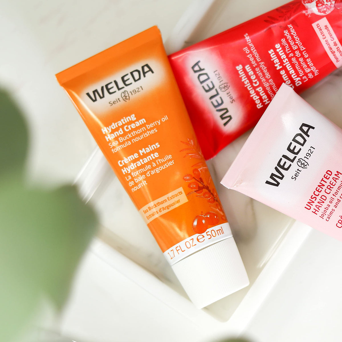 Weleda sea buckthorn applied on hands demonstrating hydration and non-greasy feel