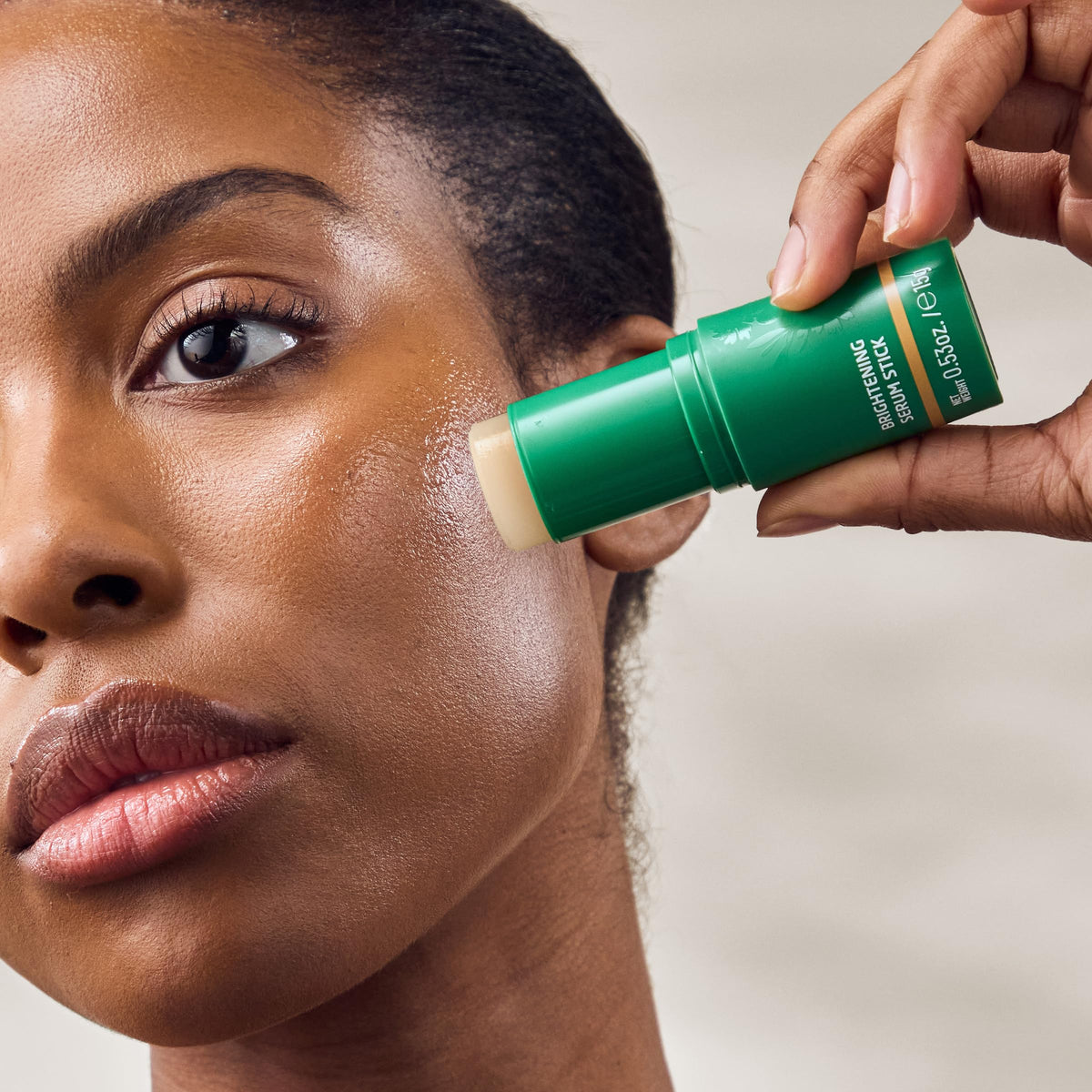 Weleda serum stick in hand showing compact travel-friendly size