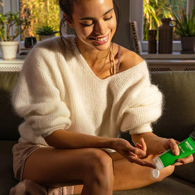 Applying Weleda Skin Food to hands for immediate softening benefit