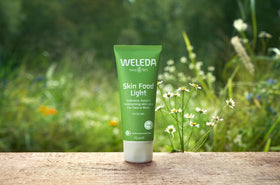 Weleda Skin Food Light next to coin for scale highlighting travel-friendly 1 fl oz