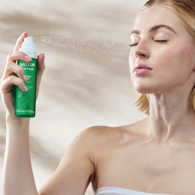 Weleda Skin Food mist held in hand to show size and travel-friendly benefit