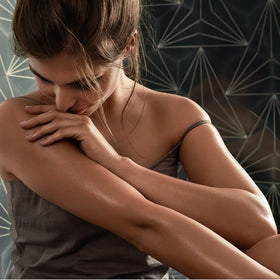 Weleda oil beside towel in bathroom conveying soothing hydration benefit