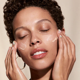 Well People hand swatch of primer showing dewy finish and hydration