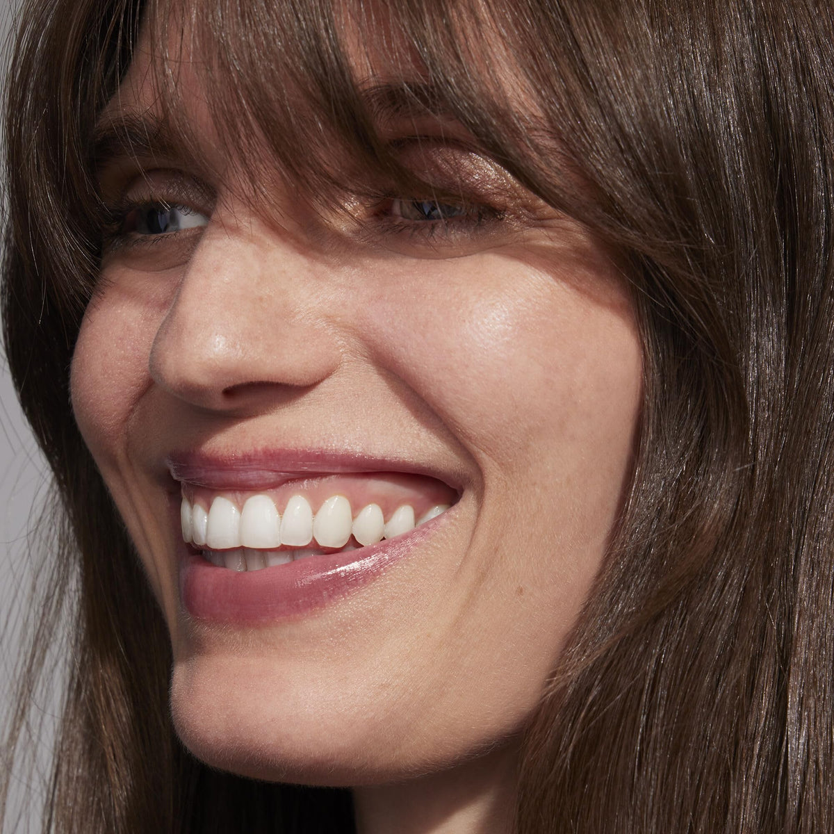 Well People close-up of lips wearing cherry blossom oil showing luminous, conditioned look