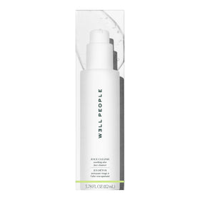 Well People cleanser next to hand showing size and travel-friendly scale