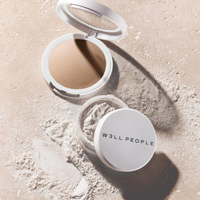 Well People powder size comparison next to hand showing compact travel-friendly benefit