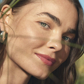 Well People Wildflower on model illustrating natural coral color and hydrated lips