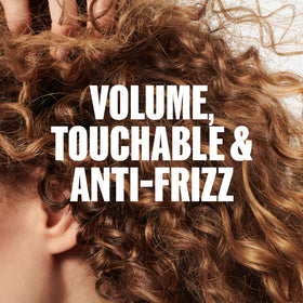 Wella Professionals foam in hand being applied for buildable volume benefit