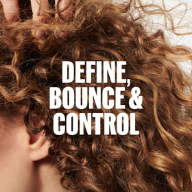 Wella Professionals applying Curl Shaper to damp curly hair to enhance curl definition and reduce frizz