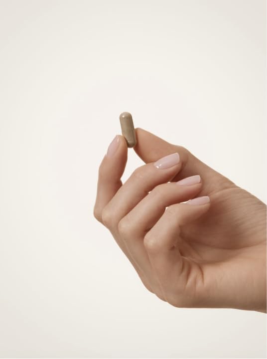 WELLBEL capsules in palm demonstrating daily three-capsule serving