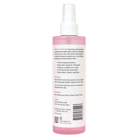 Well's Oil bottle with rose flowers flatlay emphasizing natural Rosa damascena origin