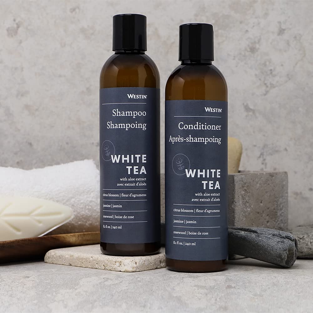 Westin White Tea Aloe bottles held next to hand to show 8-ounce scale for travel and gym bags