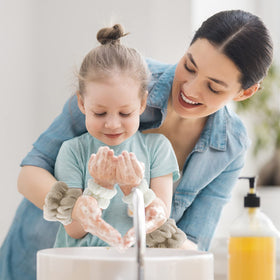 WHAVEL in use while washing face, keeps arms dry and clean