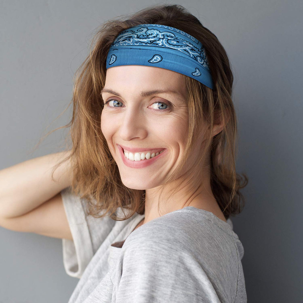 WILLBOND model wearing headband while riding motorcycle illustrating helmet compatibility
