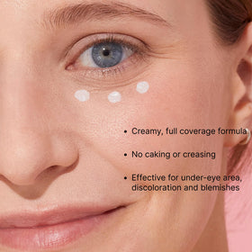 Winky Lux concealer on fingertip being dabbed under-eye demonstrating easy application and coverage