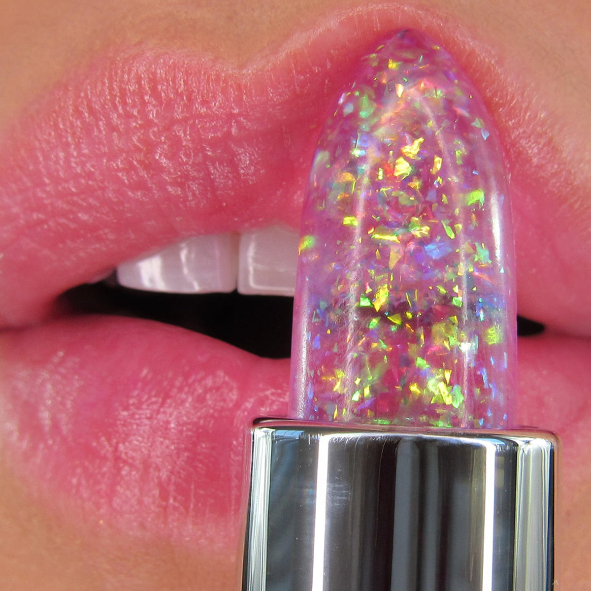 Winky Lux applied on lips showing personalized pink tint and subtle sparkle for flattering color