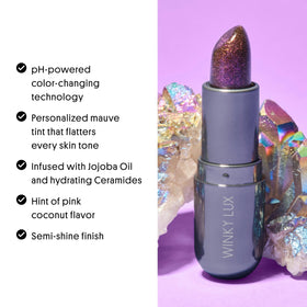 Winky Lux balm placed on a vanity with personal items showing daily-use lifestyle appeal