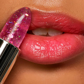 Winky Lux application on lips in mirror for instant customized pink and sheen