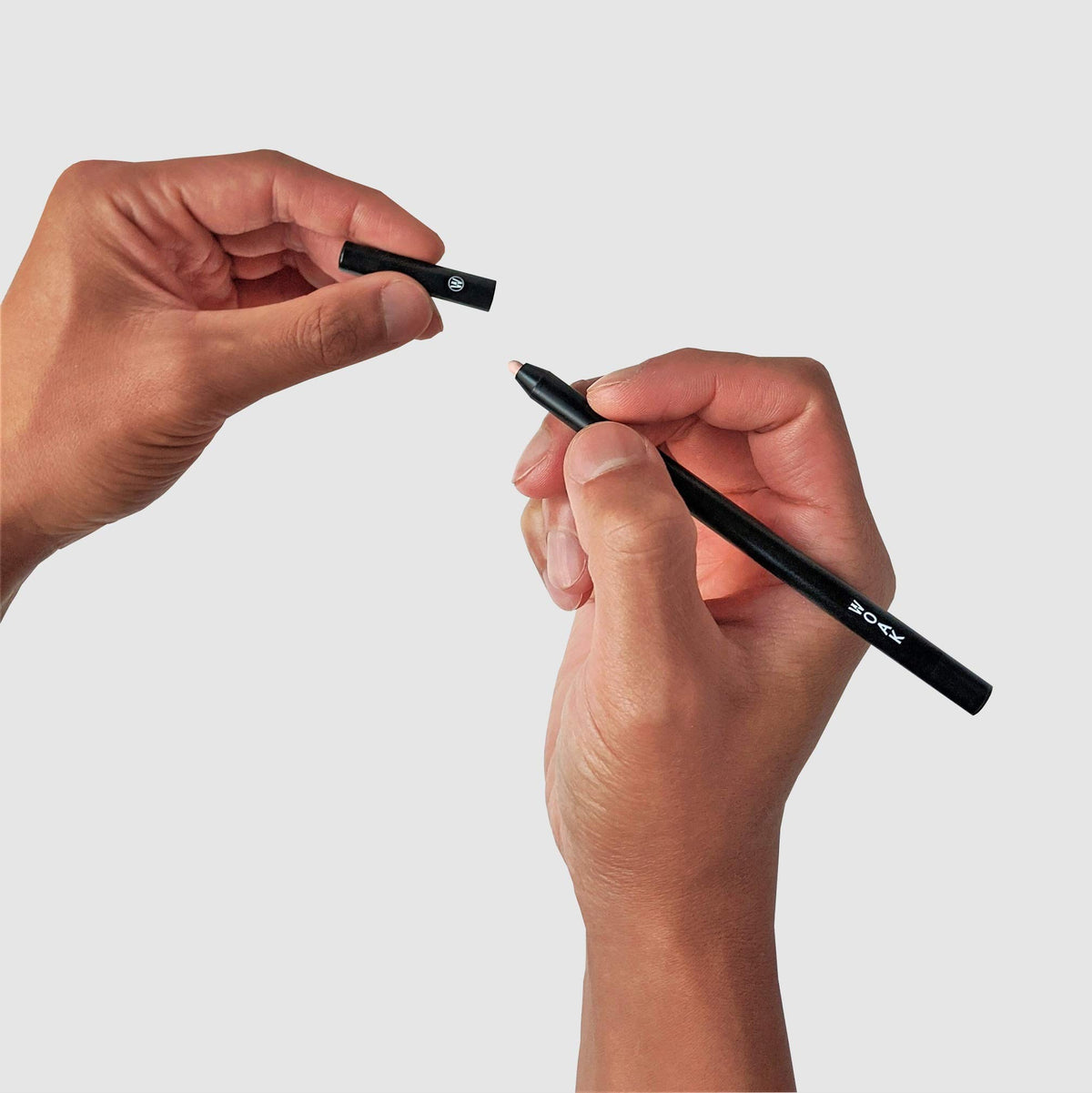 WOAK open pen with visible label and cap highlighting minimalist packaging