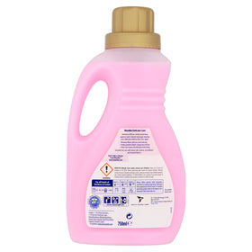 Woolite hand wash in a sink with delicate garment showing safe cleaning benefit