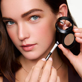 WUNDERBROW compact next to a coin showing compact size and pocketability