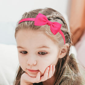 XIMA toddler in party outfit styled with bow headband for festive use