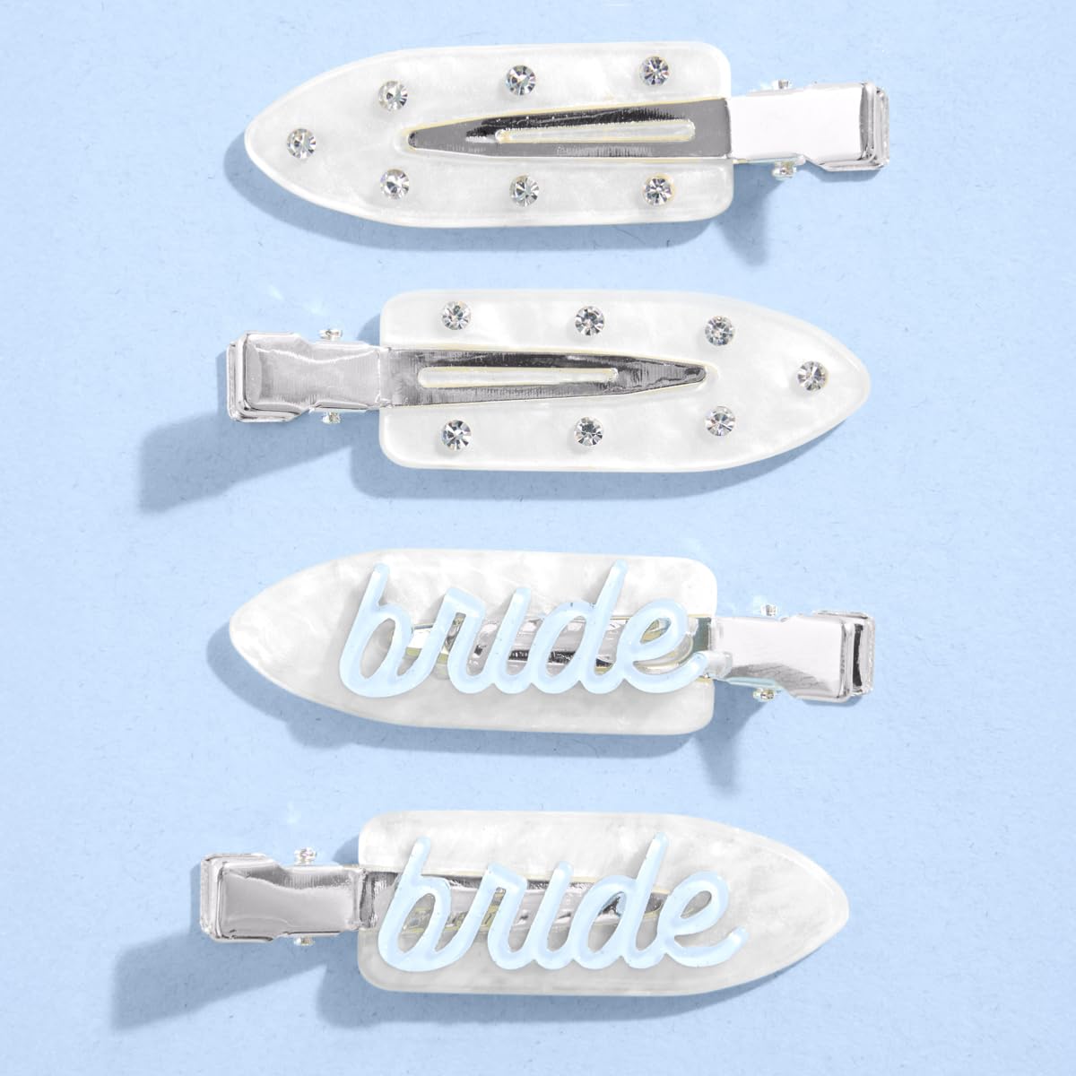 xo, Fetti front view of four white bride clips showing blue lettering and sparkle benefit