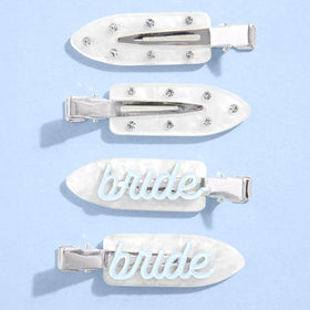 xo, Fetti front view of four white bride clips showing blue lettering and sparkle benefit