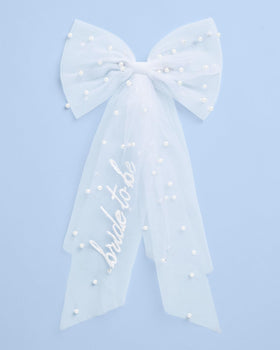 xo, Fetti model wearing bow at bachelorette showing instant celebratory style