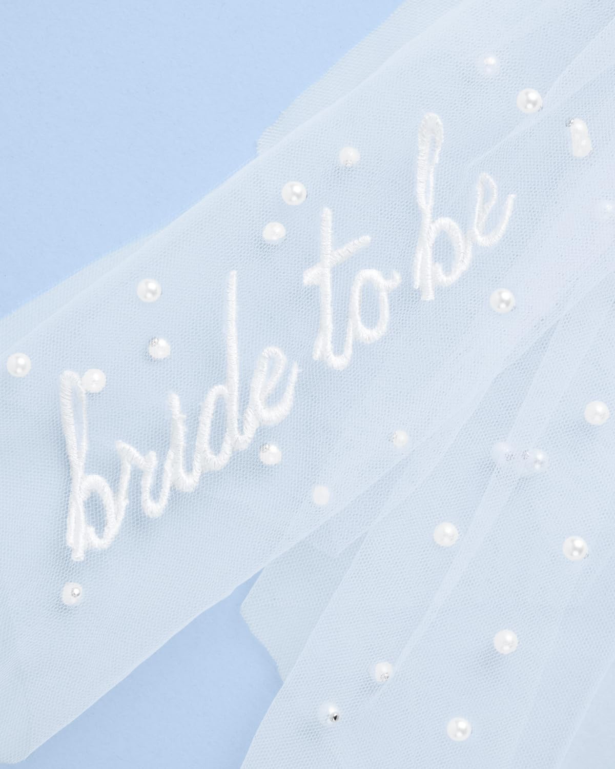 xo, Fetti detail of layered white tulle showing soft volume and flowing texture