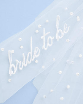 xo, Fetti detail of layered white tulle showing soft volume and flowing texture