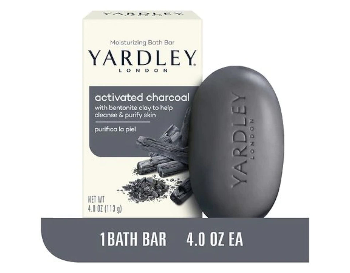 Macro shot of activated charcoal powder beside a Yardley London bar, illustrating clarifying ingredient