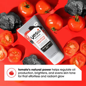 Yes To Tomatoes tube next to coin for size comparison and travel-ready benefit