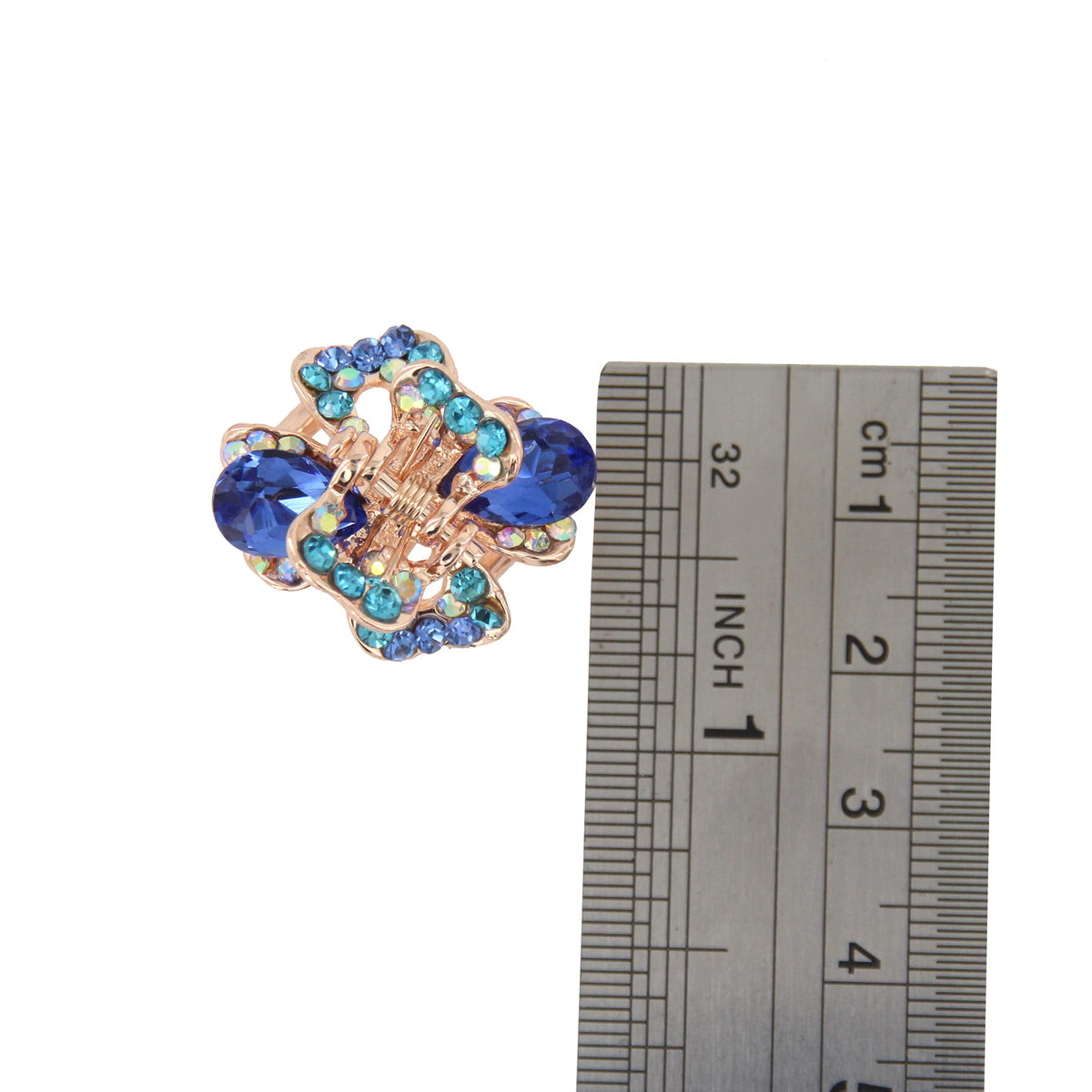 Yeshan next to a coin for size comparison showing compact 1 inch length