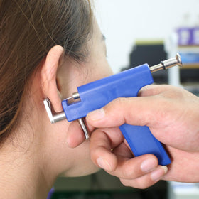YINPAD lifestyle shot with travel-ready case for on-the-go piercing