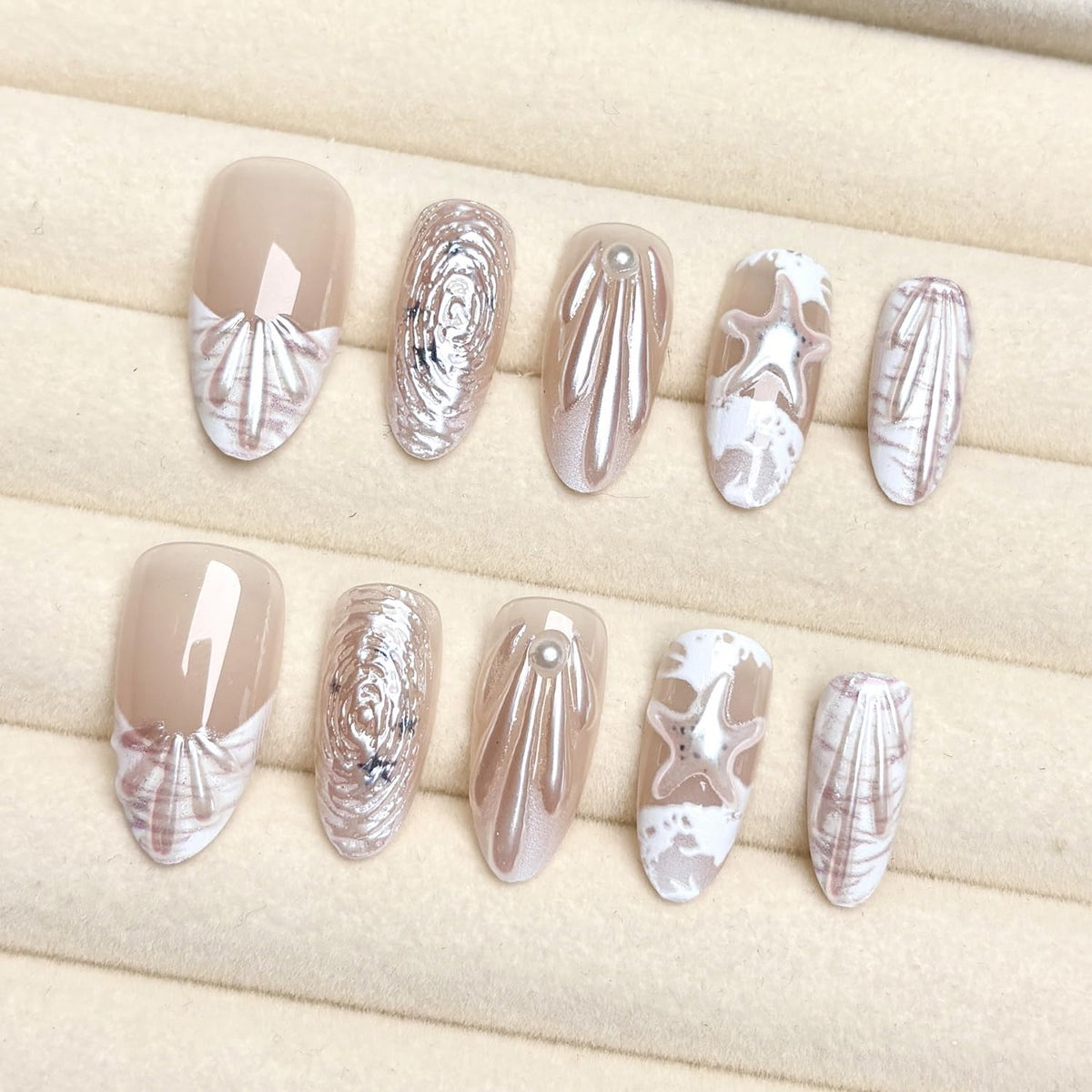ZASKHLD close-up of 3D pearl and seashell details, textured accents for eye-catching nails