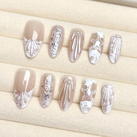 ZASKHLD close-up of 3D pearl and seashell details, textured accents for eye-catching nails