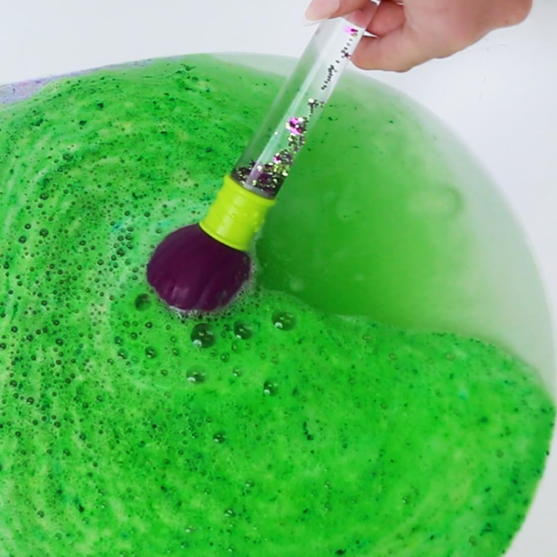 ZIMPLI bath bomb dissolving in tub, demonstrating vivid colour-changing effect and playful fizz