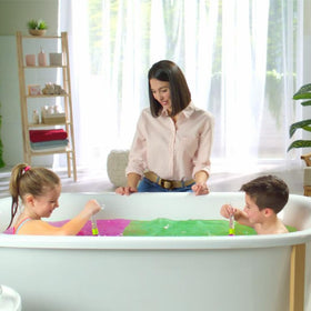 ZIMPLI lifestyle shot of child enjoying coloured bath water, showing sensory play and parental ease
