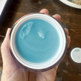 ZO-SKIN HEALTH applied to fingers and cheek in use, demonstrates gentle polish action