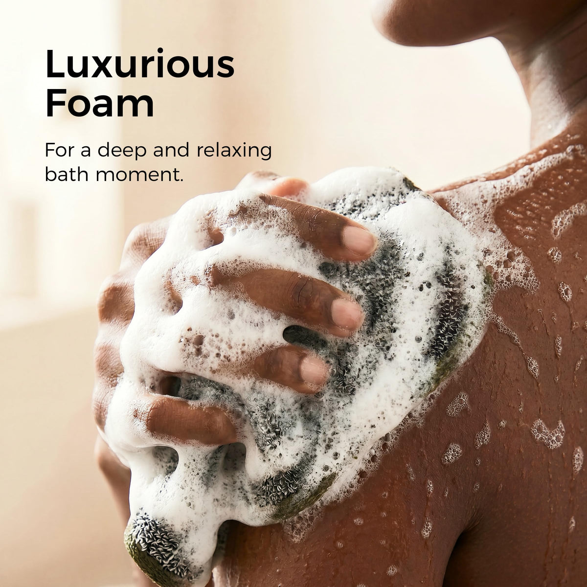 ZOMCHI towel held in hand illustrating size and easy handling for body and face